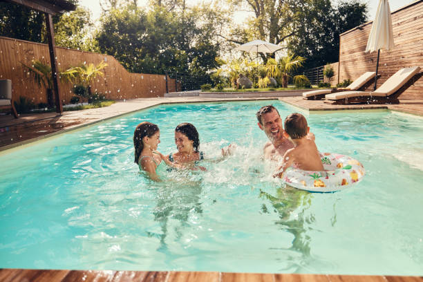 istock Cheerful family having fun during summer day in the pool. 2152850355