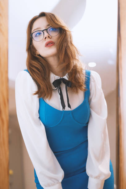 istock Young Woman is Looking at Herself in The Mirror 2152851378