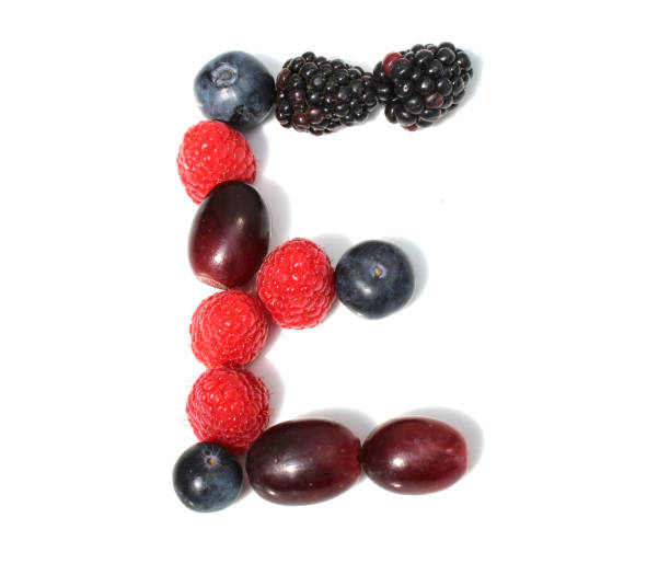 istock letter E made from raspberry, blackberry blueberries, grapes. isolated berries letter for birthday party invitation 2152851862