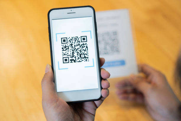 istock Close up of customer hand making payment through smart phone and scan code. 2152852534