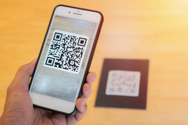 istock Male hand holding a mobile phone with qr code on the screen. scanning the qr code. 2152852540