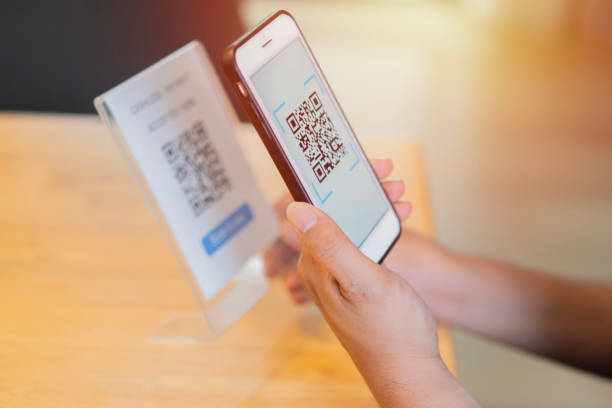 istock Side view of men's hands scan QR Code for digital payment at strore. 2152852574