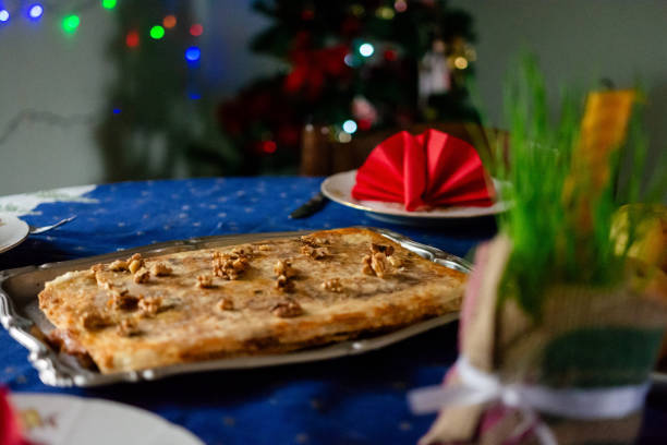 Traditional food for orthodox Christmas at the table. Christmas cake whit walnuts and wheat whit candle