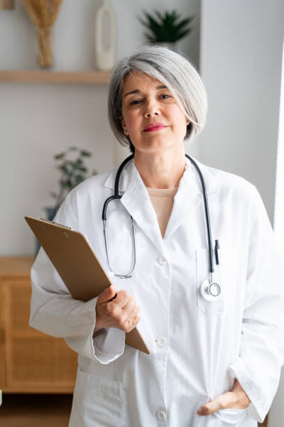 istock Confident senior female doctor with clipboard 2152853777