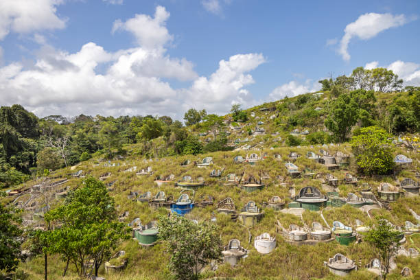 Sandakan, Eastern Borneo, Malaysia - February 13th 2024:  The Chinese graveyard spread out on a number of rolling hills behind the city - it is for ethnical Chinese no matter which religion, most has been Christians or Confucianists or a mixture