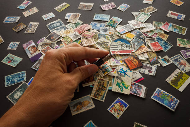 Still life with stamps and magnifying glass. Various old postage stamps.