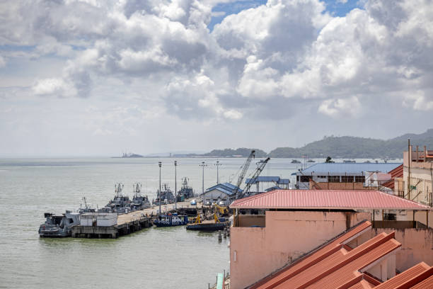 Sandakan, Eastern Borneo, Malaysia - February 12th 2024:  Naval patrol boats moored in a corner of the harbor. The city is part of the  border to Indonesia