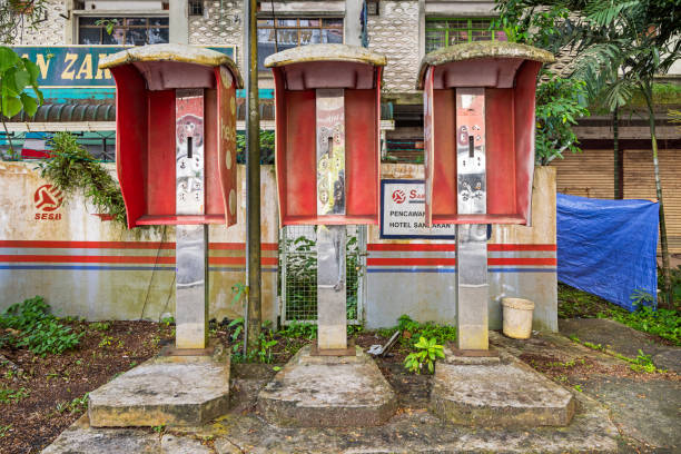 Sandakan, Eastern Borneo, Malaysia - February 13th 2024:  Empty telephone stands in the street as a symbol of the pay phones death due to mobile phones