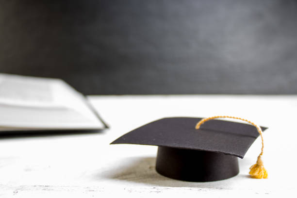 istock Open book on wooden deck table and black board background. Back to School. Education concept with copy space for your ad text. 2152861740