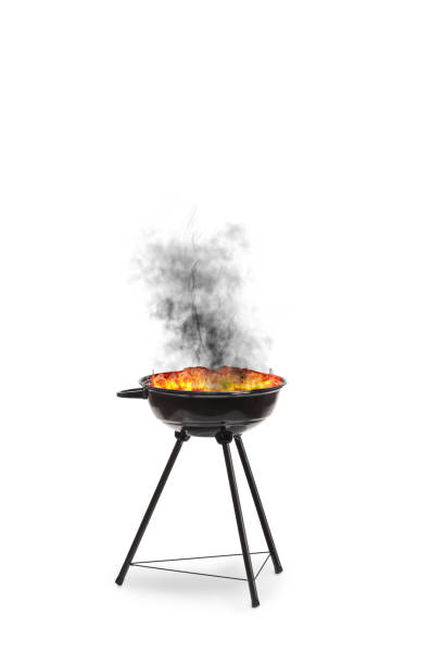 Burnt grilled meat on a barbecue with smoke isolated on white background