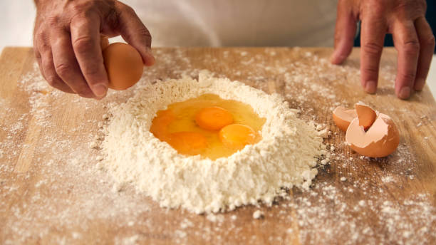 istock Overhead Shot Of Man At Home In Kitchen Mixing Eggs With Flour Making Dough On Worktop Or Counter 2152863778