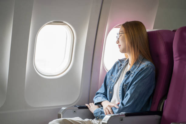 istock Young Asian tourist relaxes while traveling on a passenger plane. 2152866189