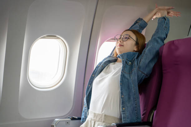 istock Young Asian tourist relaxes while traveling on a passenger plane. 2152866190