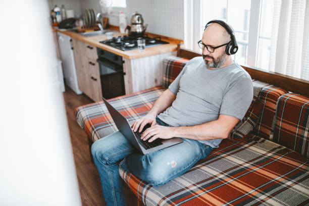 istock Using laptop and headphones for remote work from home 2152866191