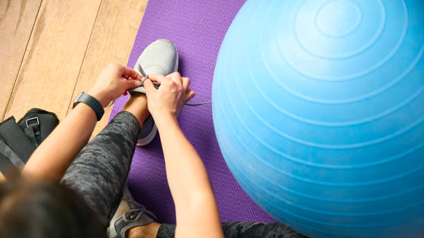 istock Close Up Looking Down On Woman About To Exercise Tying Shoelaces 2152866683