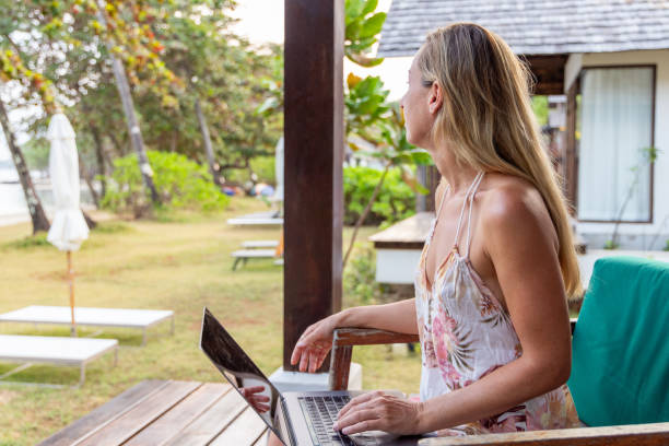 istock Woman Enjoying View While Working at Beachside Resort 2152867068