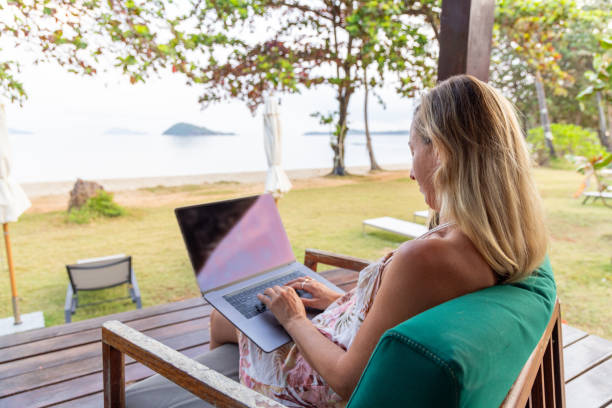 istock Woman Working on Laptop with Ocean View 2152867090