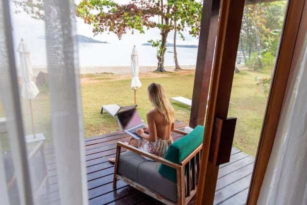 istock Woman Working on Laptop from Beachfront Porch 2152867115