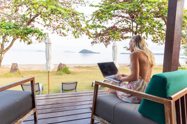 istock Woman Working Remotely with Beach View 2152867131