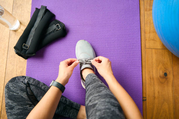 istock Close Up Looking Down On Woman About To Exercise Tying Shoelaces 2152867306