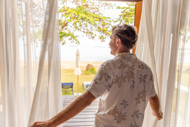 istock Man Stepping Out to a Beach View 2152869002