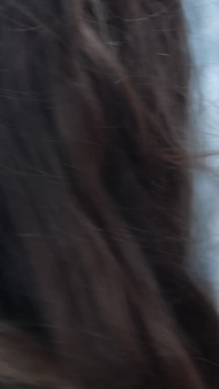 Wave hand to flirt girl looks back Canada Vancouver Wind blows smiling young woman In city center, young girl in pink dress walks in summer. female walks around city in good mood