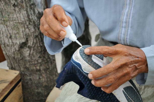 the shoe solemaker is gluing shoes