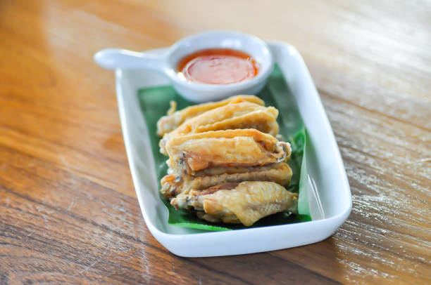 chicken wings or deep fried chicken , fried chicken and chili sauce