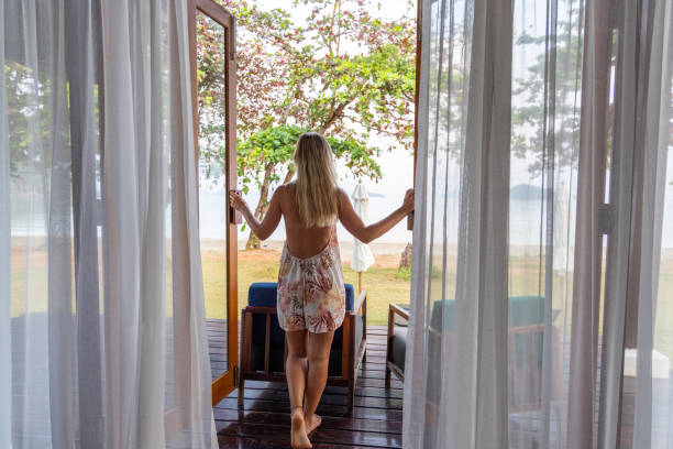 istock A Woman Embraces the Morning on Her Beachside Deck 2152873603