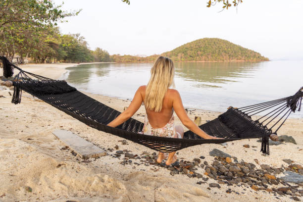 istock Woman Relaxing on a Coastal Hammock 2152874133