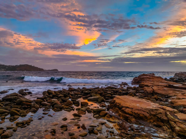 istock Summer Sunrise by the seaside with waves and clouds 2152875576