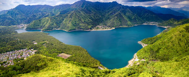 istock Panoramic aerial view of a lake surrounded by rugged mountains and forest (Saiko) 2152877939