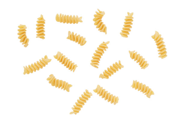 Flying or levitate raw fusilli pasta on a white background.
