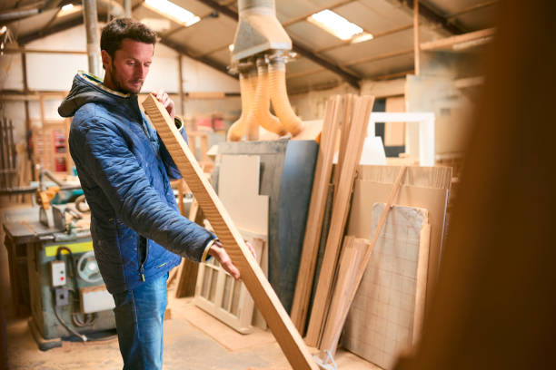 istock Carpenter Working In Woodwork Workshop Choosing Wood For Project 2152880702
