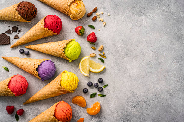 istock Multicolored fruit flavored ice cream cones shot from above on gray background. Copy space 2152882526