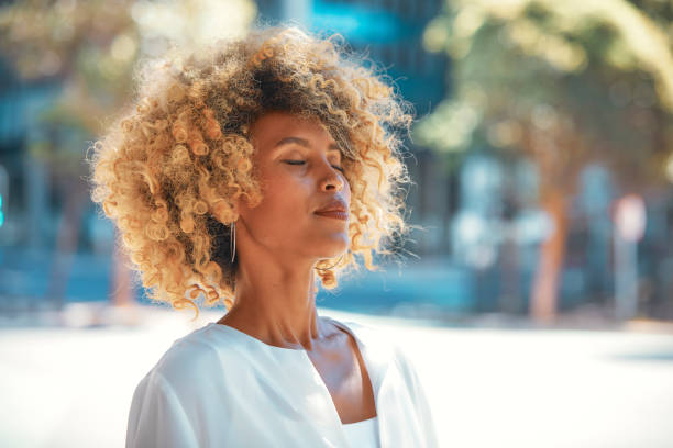 istock Urban Elegance: Beautiful Woman Against Blue Cityscape 2152883201