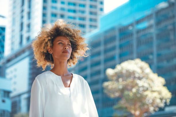 istock Urban Elegance: Beautiful Woman Against Blue Cityscape 2152883207