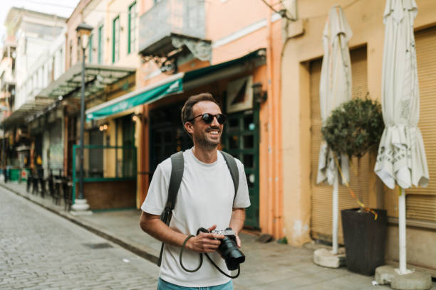 Male photographer exploring the new city while on a vacation