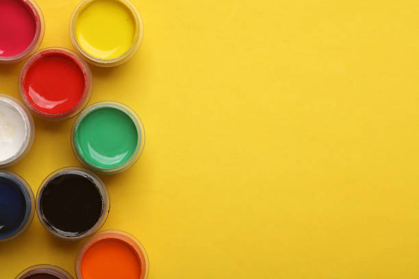 istock Jars of gouache paint on a yellow background. Copy space 2152885652