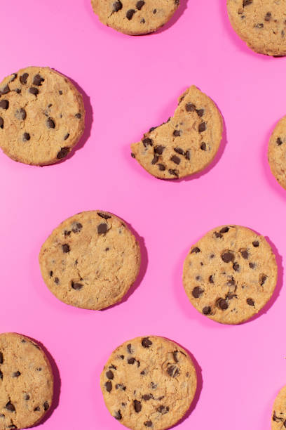 istock Fresh cookies with chocolate chips on a pink background. Dessert, a pastry shop. Pattern. 2152887987