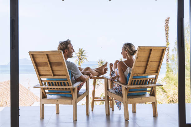 istock Couple Relaxing with Feet Up on Balcony with Ocean View 2152893654