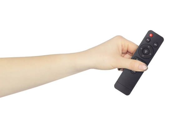 istock remote control for lamp in hand, outstretched hand with remote control for lamp isolated from background 2152893857