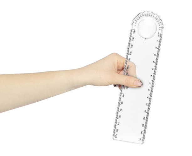istock Plastic stationery ruler in centimeters and millimeters with protractor in hand, outstretched hand with ruler isolated from background 2152893890