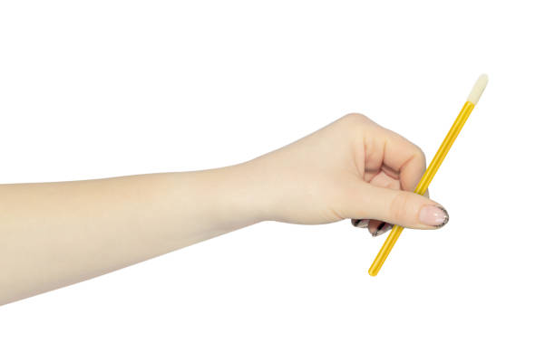 istock velor eyelash applicator in hand, outstretched hand with velor eyelash applicator isolated from background 2152893979