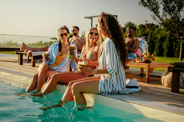group of friends having fun by the pool - パーティー ストックフォトと画像
