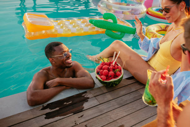 istock Friends enjoying pool and sun 2152894667