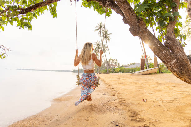istock Woman on Swing by the Beach at Sunset 2152897903
