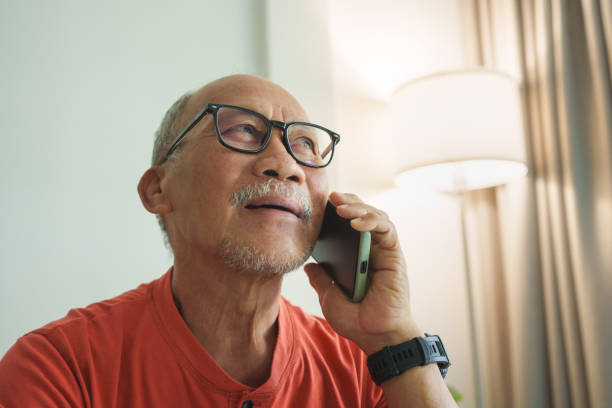 istock Smiling Elderly Asian Man Enjoying a Pleasant Conversation on His Mobile Phone. 2152898682