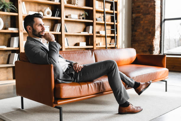 istock Relaxed young businessman having break on the sofa in modern office 2152899916