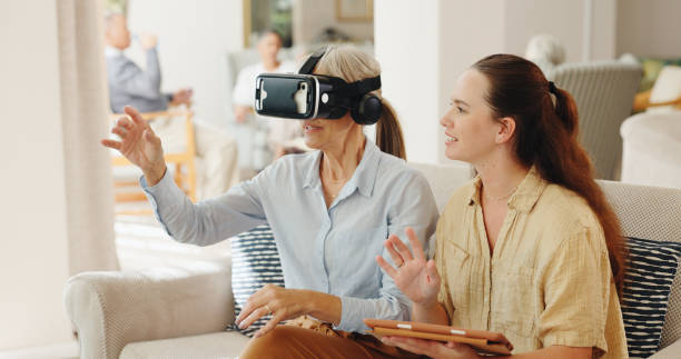 istock Senior woman, headache and virtual reality on couch with tablet for test, metaverse and caregiver in retirement home. Geriatric psychiatrist, ar vision and tired with pain in exam for dementia on app 2152901667